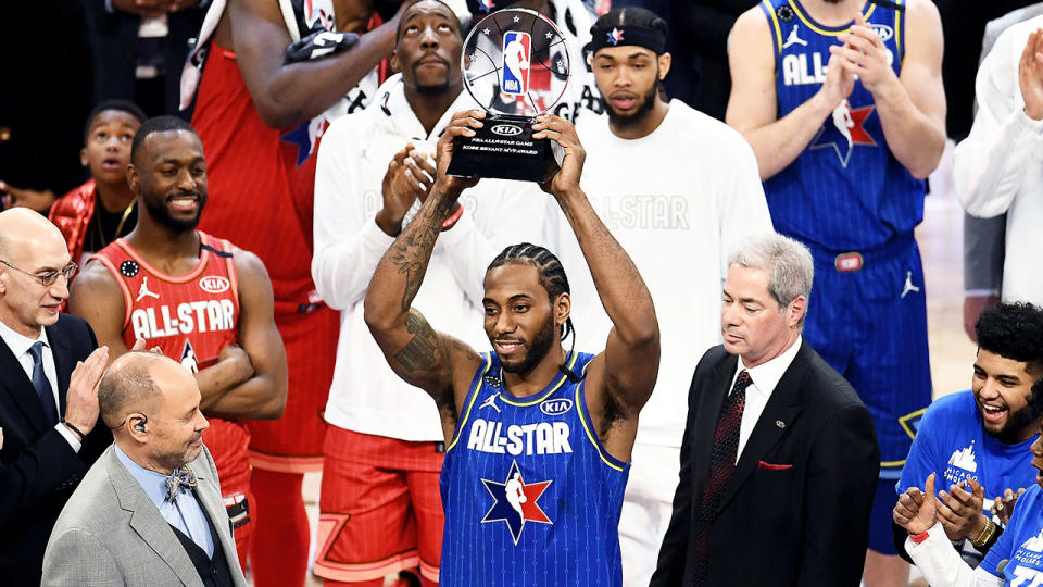 Kawhi Leonard holding up the trophy after being named the Kobe Bryant MVP.