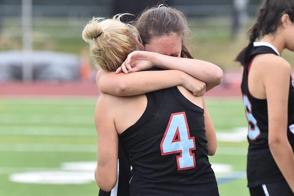 Charlotte Catholic’s Jenna Thompson (4) embraces Madeline Lewis (2) after their 15-11 loss to Cardinal Gibbs in the NCHSAA 4A Lacrosse final. The Charlotte Catholic Cougars and the Cardinal Gibbons Crusaders met in the NCHSAA 4A Girls Lacrosse Final in Durham , NC on May 19, 2023.