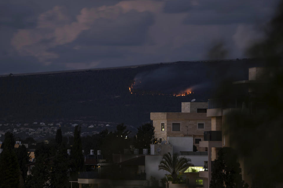 A fire burns on the Israeli side of the border with Lebanon following explosions, Sunday, Oct. 15, 2023. (AP Photo/Petros Giannakouris)