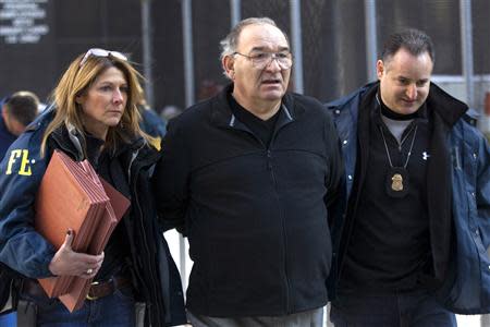 Thomas 'Tommy D' Di Fiore is escorted by FBI agents from their Manhattan offices in New York January 23, 2014. REUTERS/Brendan McDermid