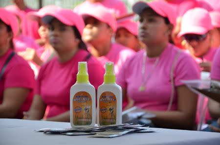 Mosquito repellent and condoms are seen in front of health workers during a campaign to fight the spread of Zika virus in Soledad municipality near Barranquilla, Colombia, in this February 1, 2016 handout photo supplied by the Soledad Municipality. REUTERS/Aleydis Coll/Soledad Municipality/Handout via Reuters