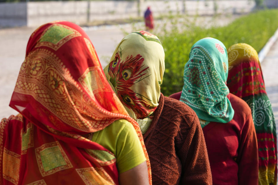 Women stand in queue to cast their votes during the first phase of Gujarat state legislature elections in Limbadi, India, Thursday, Dec. 1, 2022. The voting in Prime Minister Narendra Modi’s home state’s local elections is seen as a barometer of his ruling Bharatiya Janata Party’s popularity ahead of a general election in 2024. (AP Photo/Ajit Solanki)