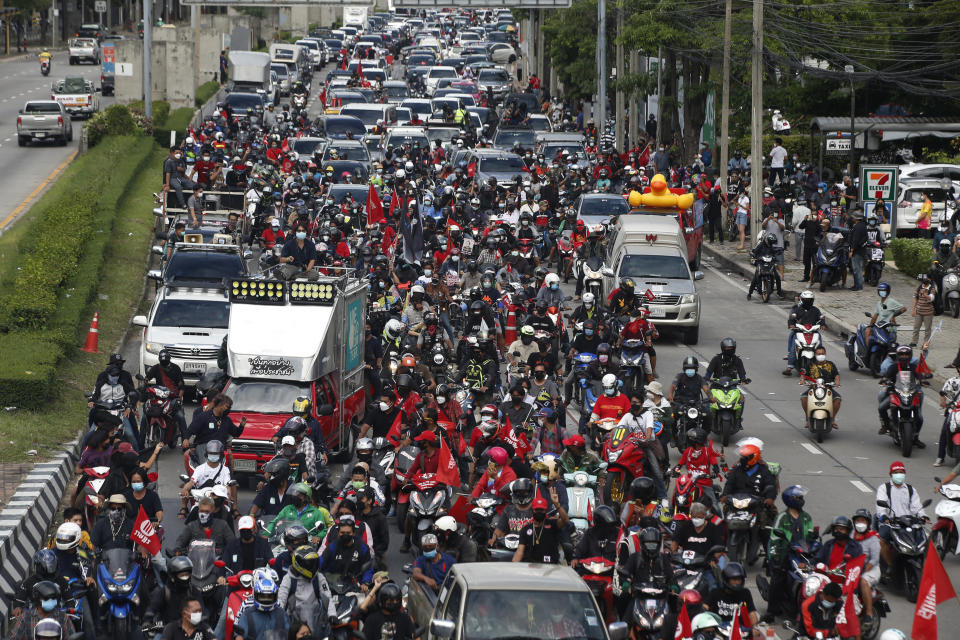 Anti-government protesters block the road with cars and motorcycles as a part of their "car mob" demonstrations along several roads in Bangkok, Thailand, Sunday, Aug. 29, 2021. A long line of cars, trucks and motorbikes wended its way Sunday through the Thai capital Bangkok in a mobile protest against the government of Prime Minister Prayuth Chan-ocha. The protesters on wheels hope their nonviolent action, dubbed a "car mob," can help force the ouster of Prayuth, whom they accuse of botching the campaign against the coronavirus. (AP Photo/Anuthep Cheysakron)