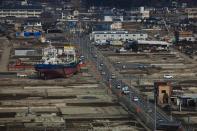 In this Feb. 23, 2012, file photo, a ship sits in a destroyed residential neighborhood in Kesennuma, Miyagi Prefecture, northeastern Japan, almost a year after an earthquake and tsunami ravaged the country's coastline. (AP Photo/David Guttenfelder, File)