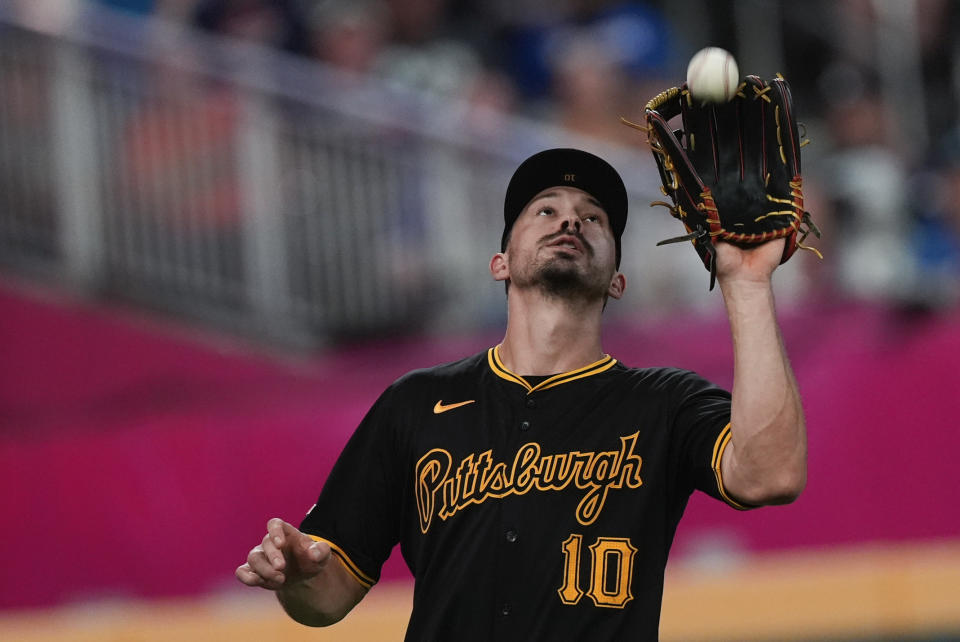 Pittsburgh Pirates left fielder Bryan Reynolds catches a flyball off the ball of Atlanta Braves' Sean Murphy in the seventh inning of a baseball game Friday, June 28, 2024, in Atlanta. (AP Photo/John Bazemore)