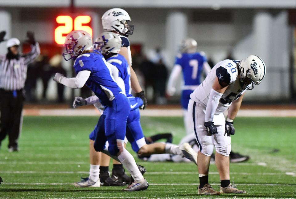 Rochester's Adam Schurr (50) reacts after the Rams' loss to Union during a class 1A WPIAL playoff game Friday night at Freedom Area High School.