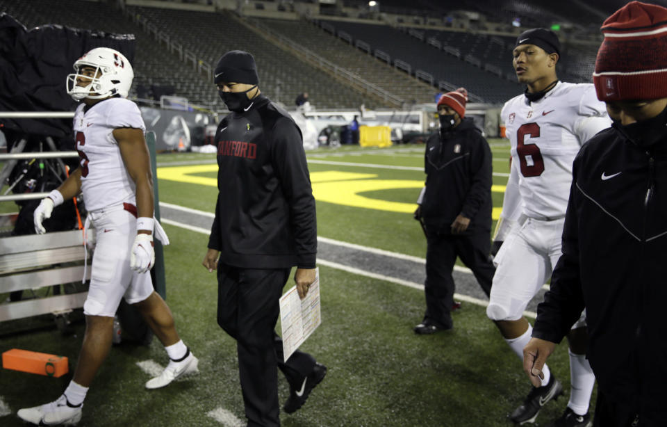 Stanford head coach David Shaw, second from left, leaves the field after being defeated by Oregon in an NCAA college football game Saturday, Nov. 7, 2020, in Eugene, Ore. (AP Photo/Chris Pietsch)