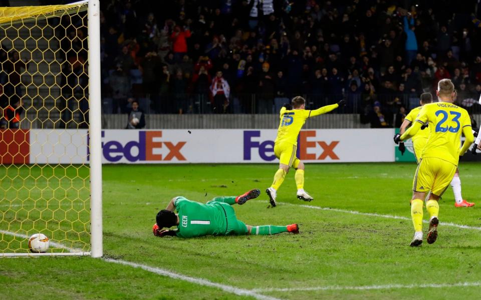 Bate's Stanislav Dragun celebrates with teammates after scoring his side's opening goal during the Europa League round of 32 first leg soccer match between Bate and Arsenal at the Borisov-Arena - AP