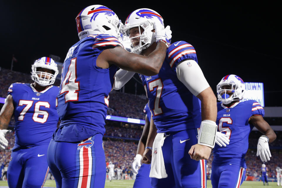 The Buffalo Bills' Stefon Diggs, second from left, celebrates with quarterback Josh Allen, second from right, after connecting for a touchdown during the second half of an NFL football game against the Buffalo Bills Tennessee 