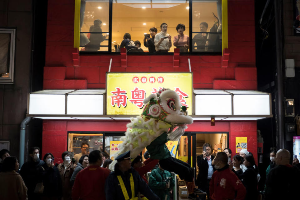 YOKOHAMA, JAPAN - JANUARY 25: A lion dance is performed outside a restaurant in Yokohama China Town on January 25, 2020 in Yokohama, Japan. Thousands of people gathered in the largest Chinese community in Japan to celebrate the Chinese Lunar New Year of the Rat. (Photo by Tomohiro Ohsumi/Getty Images)