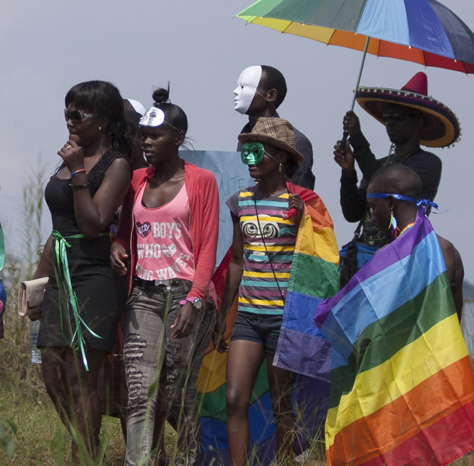 Ugandans take part in the 3rd Annual Lesbian, Gay, Bisexual and Transgender (LGBT) Pride celebrations in Entebbe, Uganda, Saturday, Aug. 9, 2014.  Scores of Ugandan homosexuals and their supporters are holding a gay pride parade on a beach in the lakeside town of Entebbe. The parade is their first public event since a Ugandan court invalidated an anti-gay law that was widely condemned by some Western governments and rights watchdogs. (AP Photo/Rebecca Vassie)