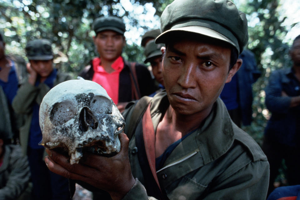 SHAN STATES, MYANMAR - 1993/01/01: A soldier of the United Wa State Army (UWSA) shows a rare human skull kept from the headhunting times of the Wa, northern Wa State.. (Photo by Thierry Falise/LightRocket via Getty Images)