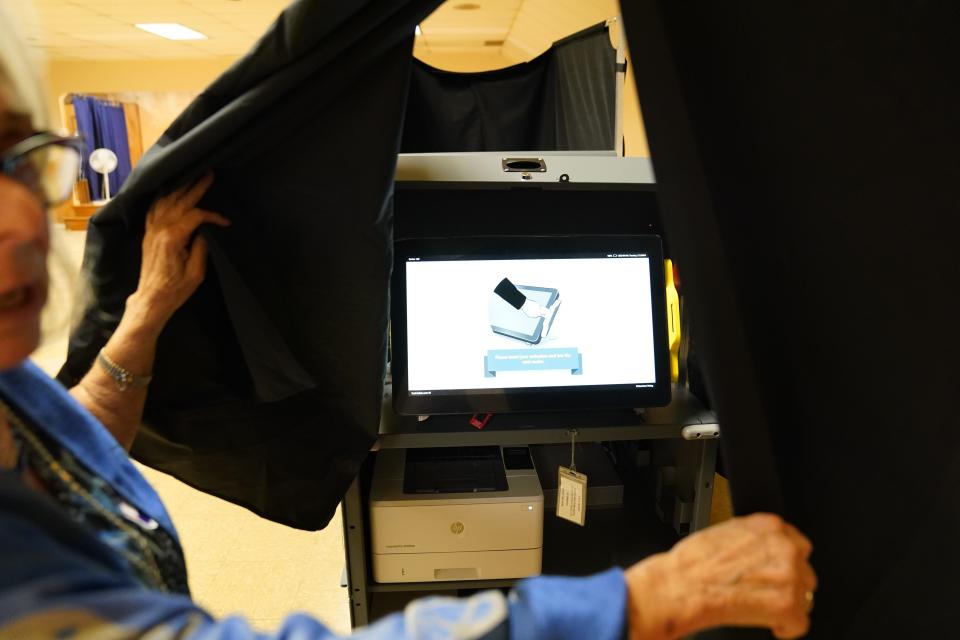 Poll worker Ronnie Lazarus, of New Milford, shows the new voting machine being used for the New Jersey primaries at a voting center in the New Milford VFW Post 4290 on June 6, 2023.