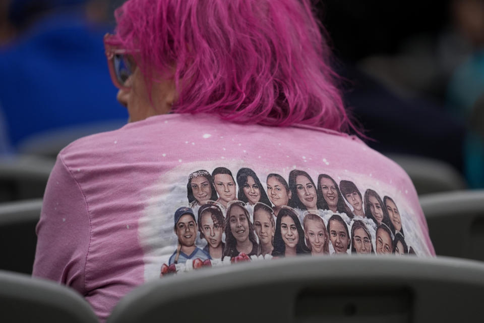 The images of 19 children and two school teachers killed in the massacre at Robb Elementary are seen on a T-shirt during a special city council meeting in Uvalde, Texas, Thursday, March 7, 2024. Almost two years after the deadly school shooting in Uvalde that left 19 children and two teachers dead, the city council met to discuss the results of an independent investigation it requested into the response by local police officers. (AP Photo/Eric Gay)