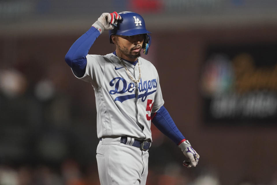 Los Angeles Dodgers' Mookie Betts gestures toward teammates after hitting a single during the fifth inning of a baseball game against the San Francisco Giants in San Francisco, Saturday, Sept. 17, 2022. (AP Photo/Jeff Chiu)