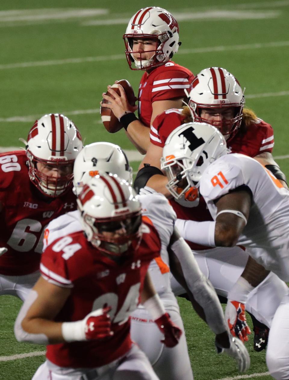 Wisconsin quarterback Graham Mertz (5) looks for a receiver during the first quarter of their game Friday, October 23, 2020 at Camp Randall Stadium in Madison, Wis. Wisconsin beat Illinois, 45-7.