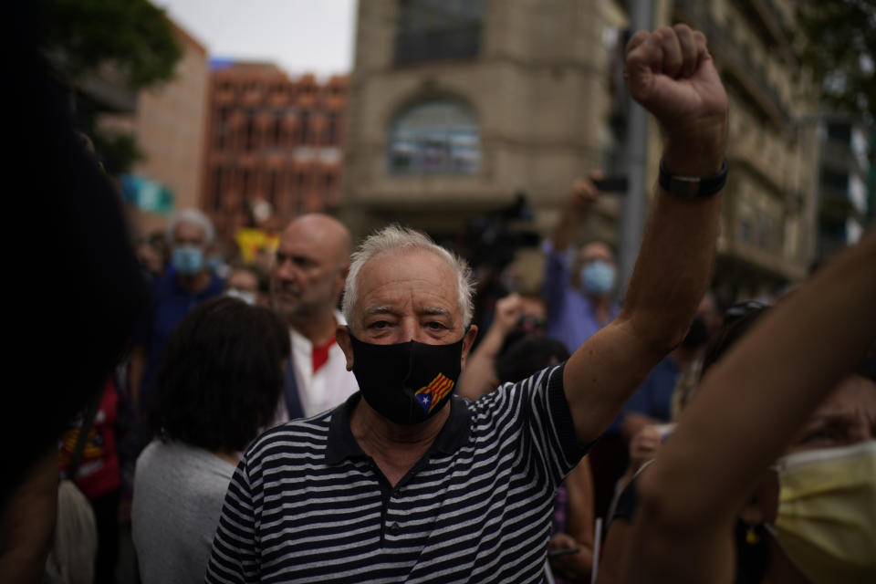 People take part in a protest outside the Italian consulate in support of former Catalan leader Carles Puigdemont in Barcelona, Spain, Friday, Sept. 24, 2021. Puigdemont, who fled Spain after a failed secession bid for the northeastern region in 2017, was detained Thursday in Sardinia, Italy, his lawyer said. Puigdemont, who lives in Belgium and now holds a seat in the European Parliament, has been fighting extradition to Spain, which accused him and other Catalan independence leaders of sedition. (AP Photo/Joan Mateu)