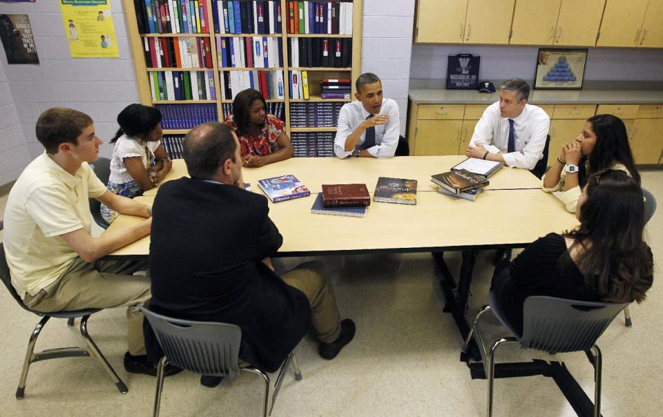 FILE - This May 4, 2012 file photo shows President Barack Obama, center, and Education Secretary Arne Duncan, right, meeting with students and their parents at Washington-Lee high school in Arlington, Va. Loose ends and thorny partisan tensions on education await the next Congress and President Barack Obama's second term. First up is the fiscal cliff, which will slash billions from the Department of Education's budget if lawmakers don't act this year. From left are, Brendan Craig, Kezia Truesdale, Amirah Delwin, Rina Castaneda, Elma Molina, and Tim Craig. (AP Photo/Pablo Martinez Monsivais, File)