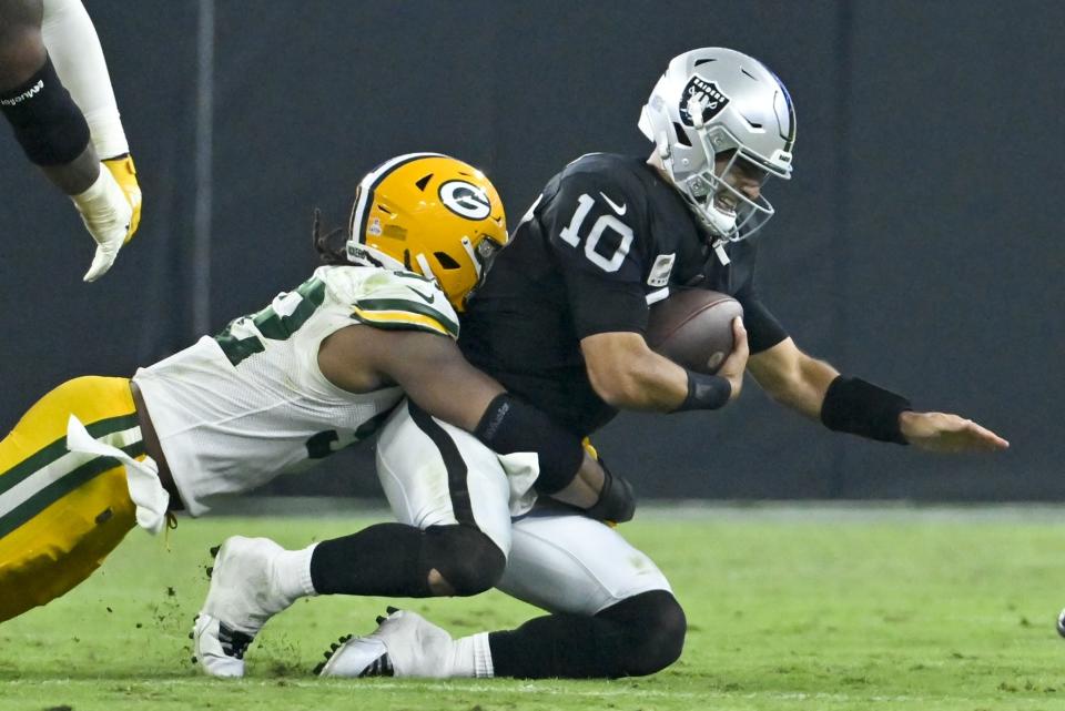 Green Bay Packers' Rashan Gary sacks Las Vegas Raiders' Jimmy Garoppolo during the second half of an NFL football game Monday, Oct. 9, 2023, in Las Vegas. (AP Photo/David Becker)