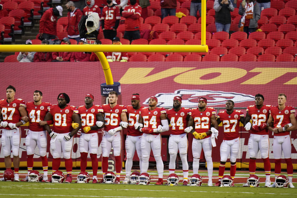 FILE - In this Thursday, Sept. 10, 2020 file photo, Kansas City Chiefs players stand for a presentation on social justice before an NFL football game against the Houston Texans Thursday, Sept. 10, 2020, in Kansas City, Mo. The NFL's new stance encouraging players to take a stand against racial injustice got its first test as some fans of the Super Bowl champion Kansas City Chiefs booed during a moment of silence to promote the cause, touching off a fresh debate on how players should use their voice. (AP Photo/Charlie Riedel, File)