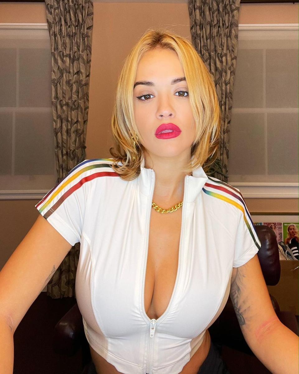 Rita Ora in a zipped down white crop top