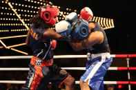 <p>New York’s Finest Yaate Turner, left, and Greg Thuesday battle in the ring during the NYPD Boxing Championships at the Theater at Madison Square Garden on June 8, 2017. (Photo: Gordon Donovan/Yahoo News) </p>