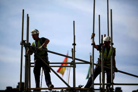 Workers build a pipe structure on a scaffolding during the World Day for Safety and Health at Work in the Andalusian capital of Seville, southern Spain April 28, 2016. REUTERS/Marcelo del Pozo/File Photo