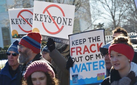 Activists protest after Mr Trump approved the US-Canada Keystone XL oil pipeline, saying it would create jobs and improve America's energy security - Credit: Mandel Ngan/AFP