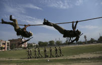 Special police officer recruits who completed nearly three months physical training demonstrate their skills at Kathua in Indian-controlled Kashmir, Saturday, June 5, 2021. Special police officers are lower-ranked police officials who are mainly recruited for intelligence gathering and counterinsurgency operations. In recent years, the force has assisted in border areas as well because of local recruits' familiarity with the topography and ability to assist police and border guards during emergencies. (AP Photo/Channi Anand)