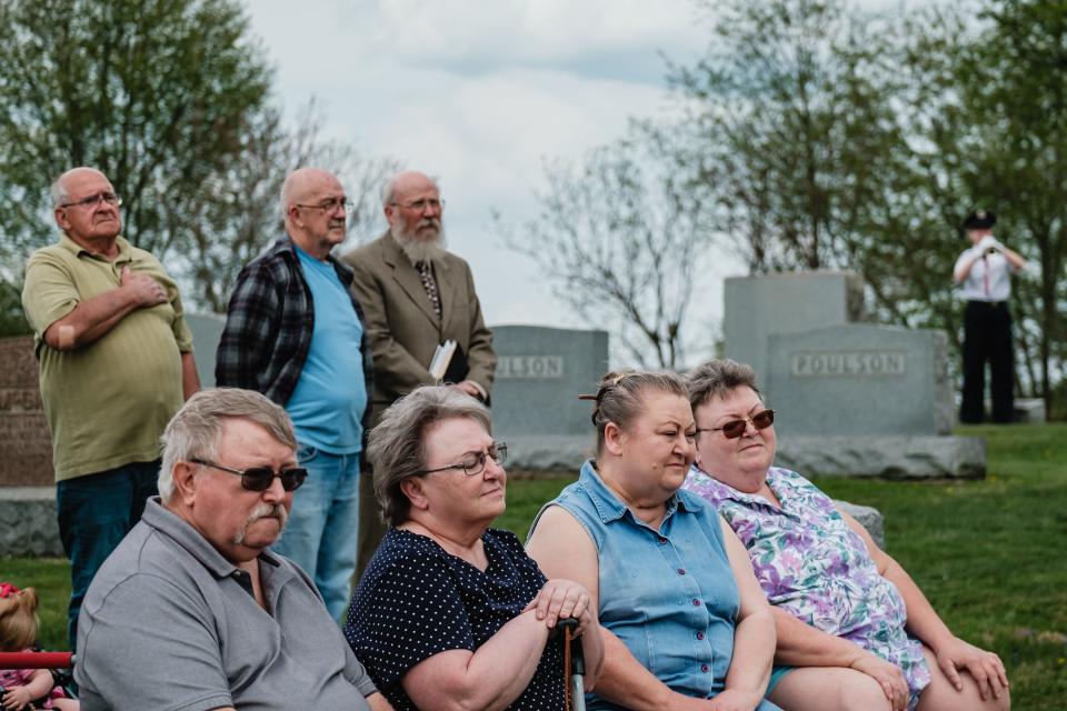 Relatives of William Clyde Garner listen to taps played Friday at Patterson-Union Cemetery in Deersville. Garner died in 1980, but was not given military honors at the time. Pictured from left at bottom are four of Garner's relatives: William Wesley Garner, Joyce Ziegler, Cheryl Garner and Marlene Garner.