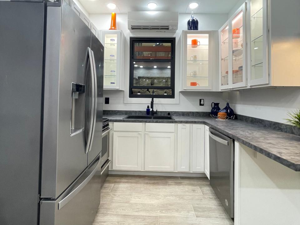 the kitchen with a fridge, sink, countertop, storage