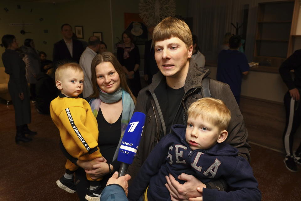 A family talk with journalists while waiting to leave the sanatorium after their quarantine period has ended in Bogandinsky in the Tyumen region, about 2150 kilometers (1344 miles) east of Moscow, Russia, Wednesday, Feb. 19, 2020. On Wednesday, 144 people who were evacuated from the epicenter of the CONVID-19 coronavirus outbreak in Wuhan, China, were released from a 14-day quarantine in western Siberia. None of them tested positive for the virus. (AP Photo/Maxim Slutsky)