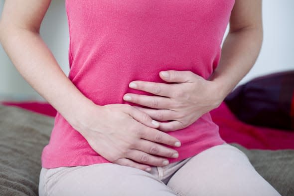 Woman suffering from abdominal pain.