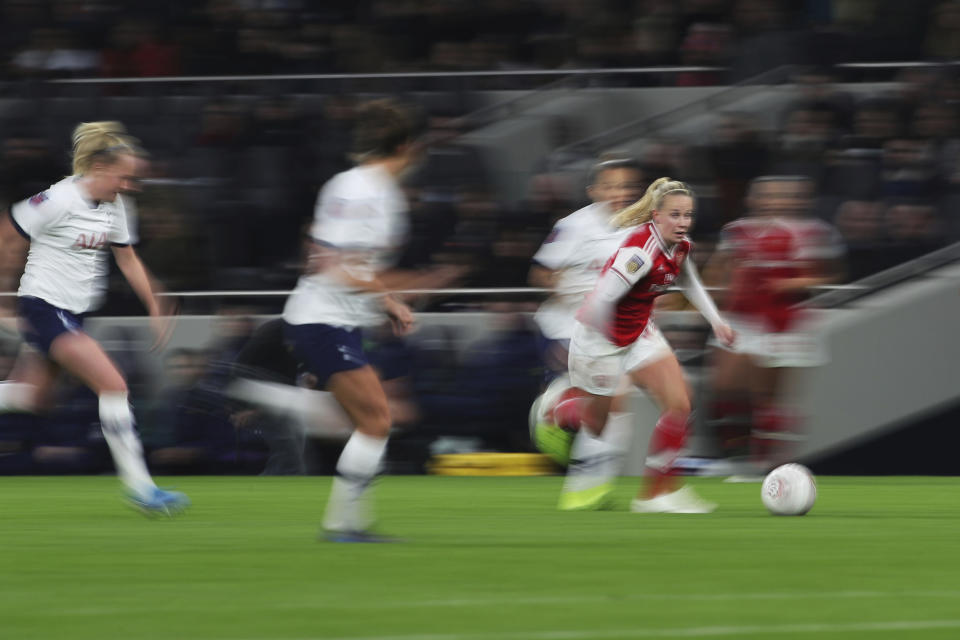 Arsenal's Beth Mead runs with the ball against Tottenham Hotspur, during their Women's Super League soccer match at the Tottenham Hotspur Stadium in London, Sunday Nov. 17, 2019. The match drew a record crowd of 38,262 for the competition on Sunday when Arsenal claimed a 2-0 victory at Tottenham. (Zac Goodwin/PA via AP)