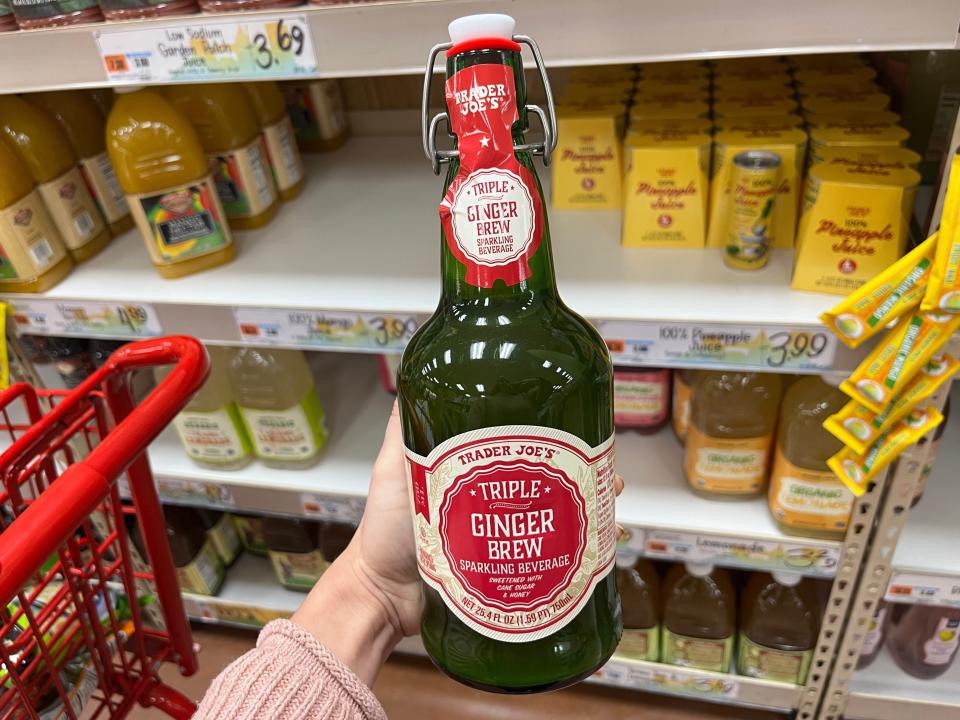 The writer holds a bottle of triple ginger brew at Trader Joe's