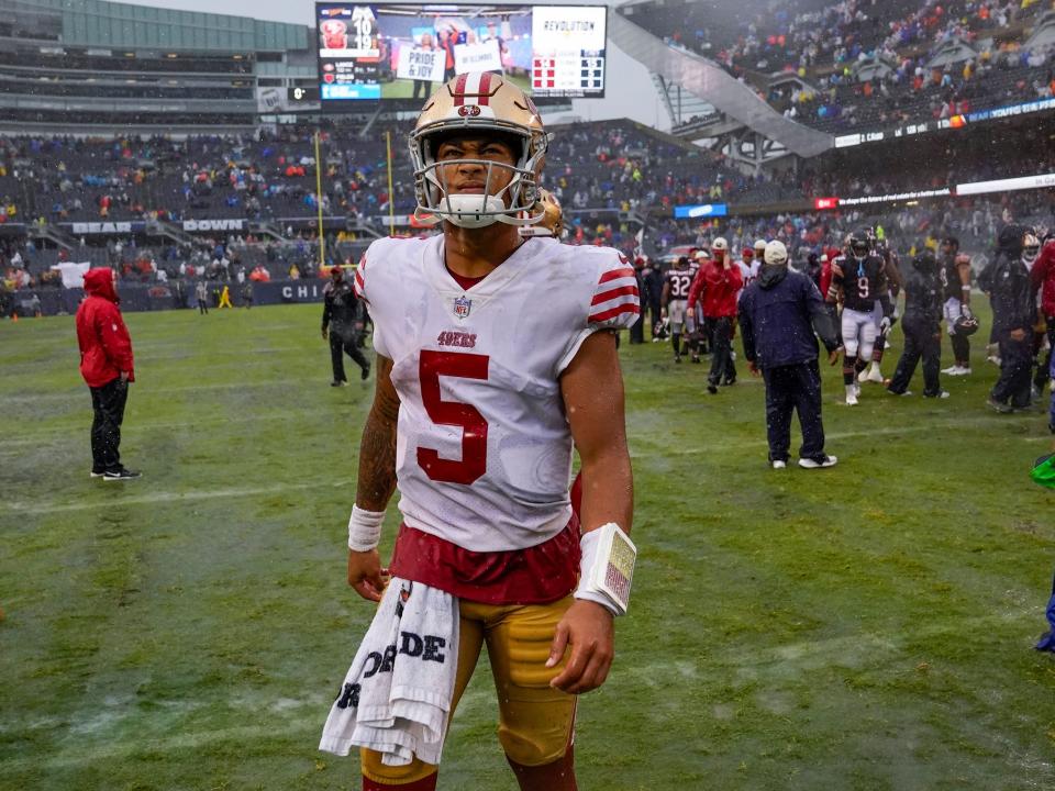 Trey Lance walks off the field after a loss to the Chicago Bears.