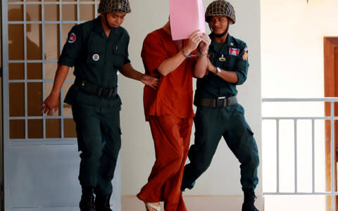 Daniel Richard Leeming Jones is escorted by the police during his trial, after he was found guilty of producing pornography - Credit: REUTERS