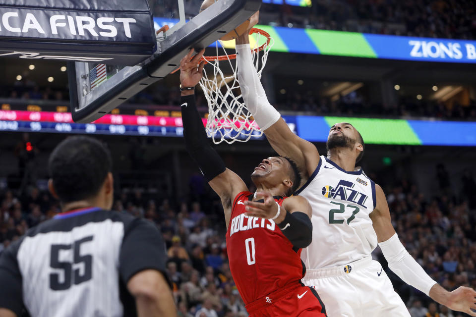 Houston Rockets' Russell Westbrook (0) attempts a layup as Utah Jazz's Rudy Gobert (27) defends during the first half of an NBA basketball game Saturday, Feb. 22, 2020, in Salt Lake City. (AP Photo/Kim Raff)