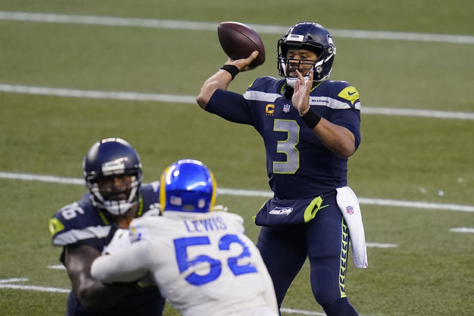 Seattle Seahawks quarterback Russell Wilson (3) passes for a touchdown against the Los Angeles Rams during the second half of an NFL football game, Sunday, Dec. 27, 2020, in Seattle. The Seahawks won 20-9. (AP Photo/Elaine Thompson)