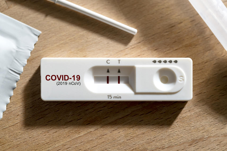 An open COVID-19 test kit on a table.