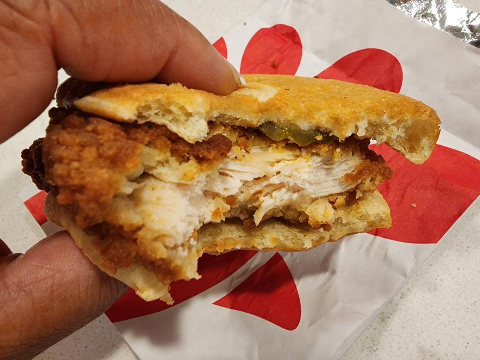 A sandwich with a bite taken out of it from Chick-fil-A