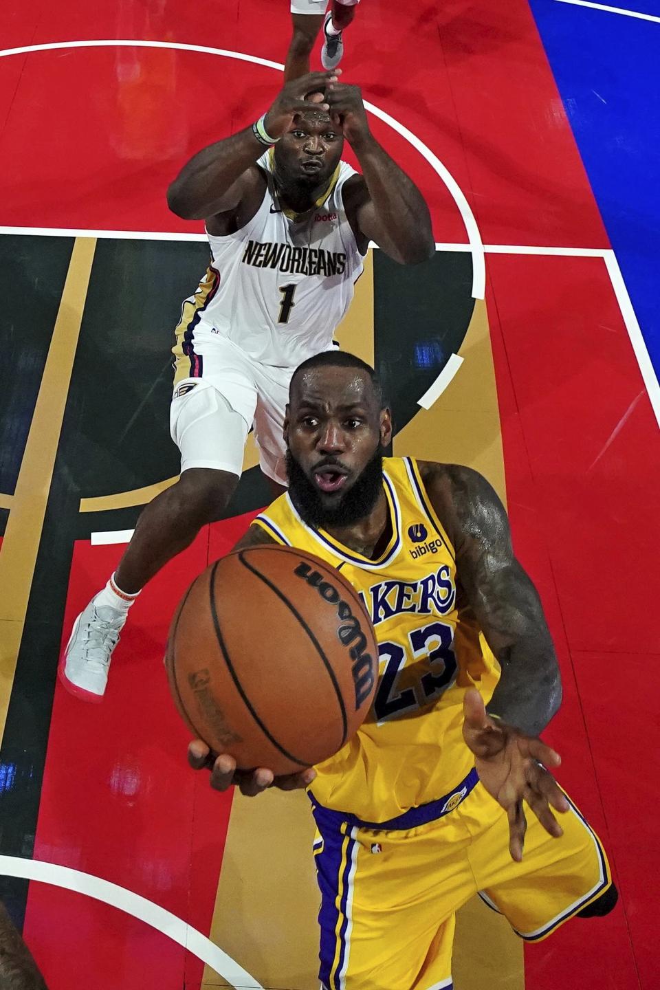 Los Angeles Lakers forward LeBron James (23) shoots the ball against New Orleans Pelicans forward Zion Williamson (1) during a semifinal game in the NBA basketball In-Season Tournament, Thursday, Dec. 7, 2023, in Las Vegas. (Kyle Terada/Pool Photo via AP)