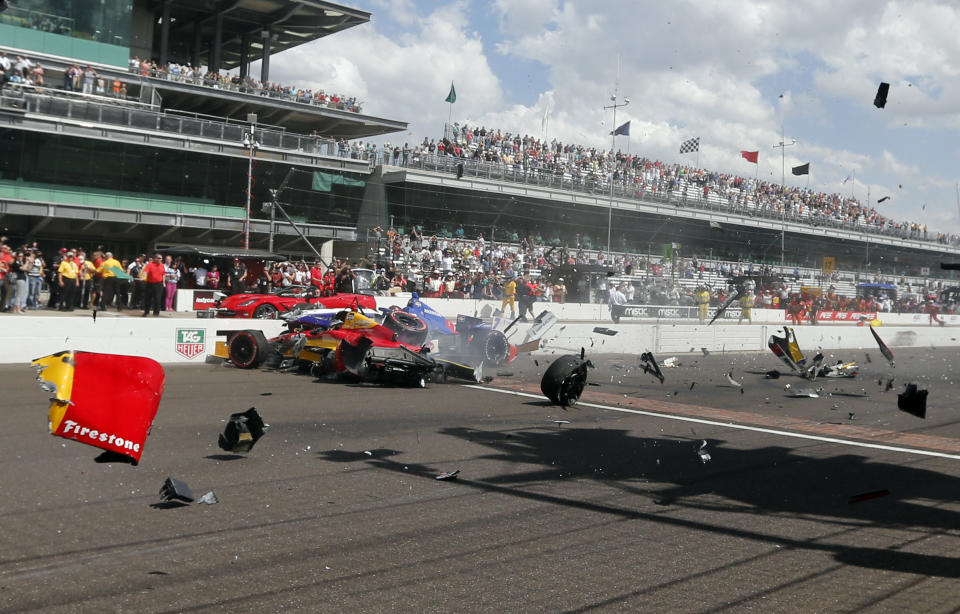 Sebastian Saavedra, left, of Colombia, is hit by Mikhail Aleshin, of Russia, at the start of the inaugural Grand Prix of Indianapolis IndyCar auto race at the Indianapolis Motor Speedway in Indianapolis, Saturday, May 10, 2014. (AP Photo/Robert Baker)