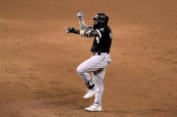 Chicago White Sox's Josh Harrison celebrates after hitting an RBI single during the sixth inning of a baseball game against the Kansas City Royals Wednesday, Aug. 10, 2022, in Kansas City, Mo. (AP Photo/Charlie Riedel)