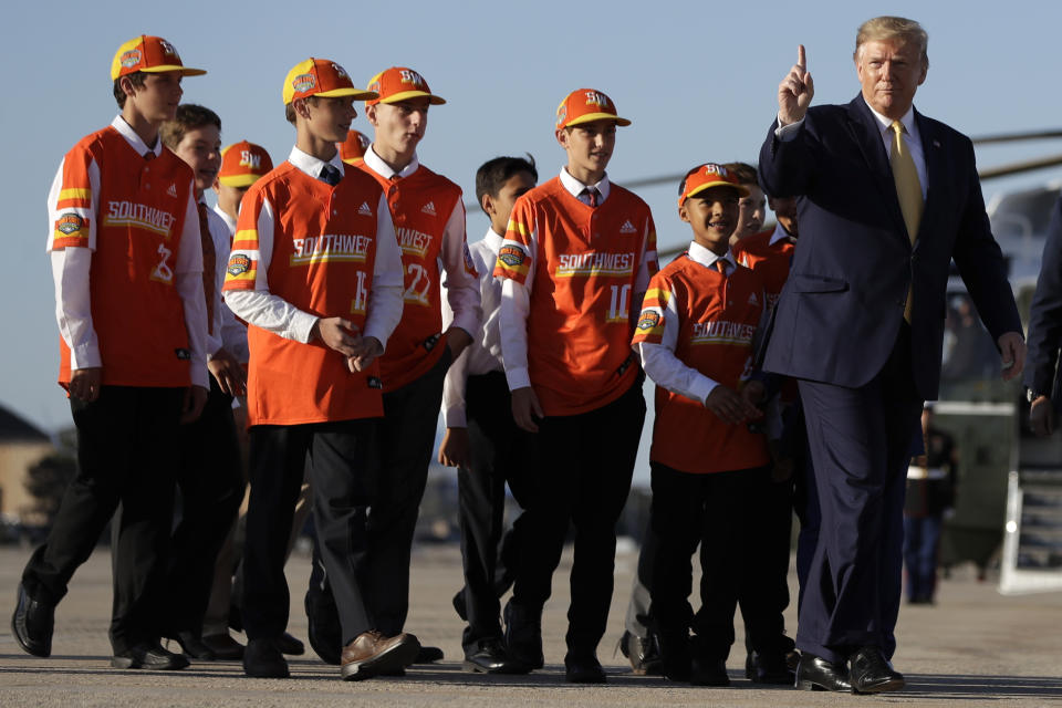 President Donald Trump walks to board Air Force One with Louisiana's Eastbank Little League team who won the 2019 Little League Baseball World Series Friday, Oct. 11, 2019, in Andrews Air Force Base, Md. Trump was heading to a campaign rally in Lake Charles, La. (AP Photo/Evan Vucci)