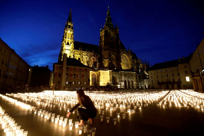 FILE PHOTO: People light candles to commemorate COVID-19 victims in Prague