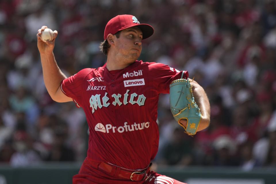 Diablos Rojos' pitcher Trevor Bauer throws against New York Yankees' Anthony Volpe during the first inning of a baseball exhibition game at Alfredo Harp Helu Stadium in Mexico City, Sunday, March 24, 2024. (AP Photo/Fernando Llano)