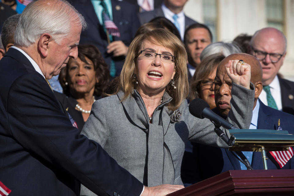 FILE - In this Wednesday, Oct. 4, 2017, file photo, former U.S. Rep. Gabby Giffords, of Arizona, joins other Democrats in a call for action on gun safety legislation on the House steps at the Capitol in Washington. As a mob laid siege to the U.S. Capitol this week, former Rep. Gabby Giffords could only wait nervously for news about her husband, Mark Kelly, who was barely a month into his job as a newly elected senator from Arizona. A decade earlier it was Kelly enduring the excruciating wait for news about Giffords, who was shot in the head in an attempted assassination that, like Wednesday's siege, shocked the nation and prompted a reckoning about the state of politics and discourse in the United States. (AP Photo/J. Scott Applewhite, File)