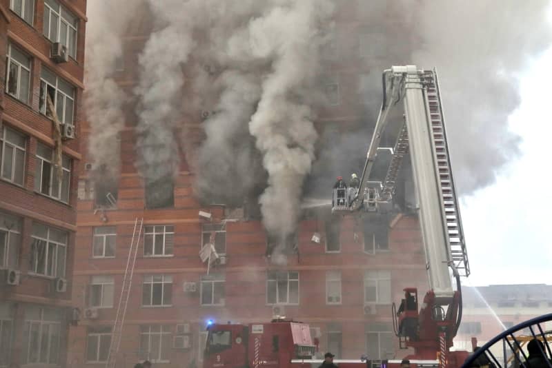 Firefighters extinguish a fire at a residential building affected by the massive Russian missile and drone attack in Odessa, southern Ukraine. -/Ukrinform/dpa