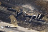 Investigators survey the site of a train derailment near the hamlet of Gainford, west of Edmonton October 20, 2013. The Canadian National Railway train carrying petroleum crude oil and liquefied petroleum gas derailed west of Edmonton, Alberta, the Transportation Safety Board of Canada said on October 19. REUTERS/Dan Riedlhuber (CANADA - Tags: DISASTER TRANSPORT)